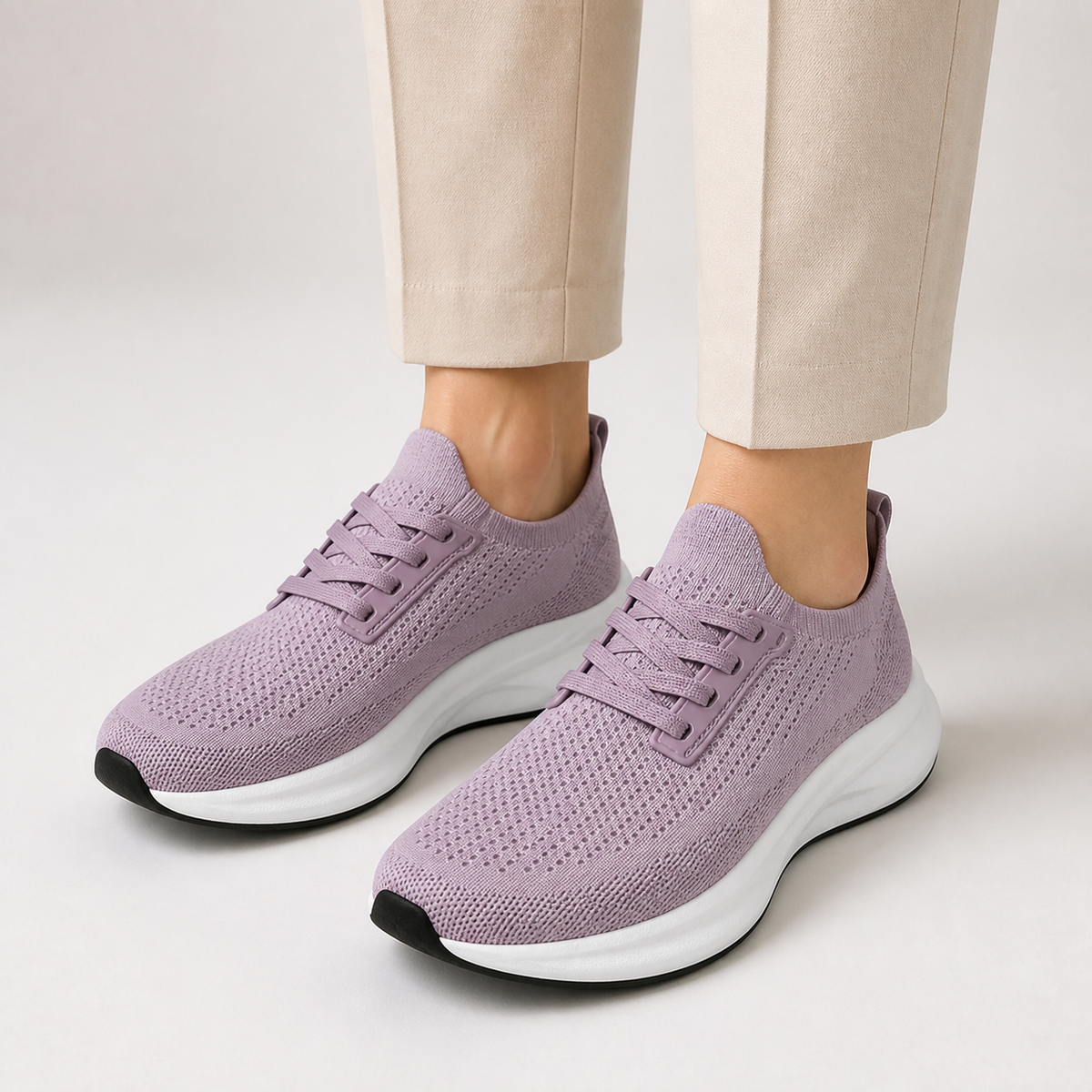 Dusty mauve wide toe trainers worn with cream tailored trousers