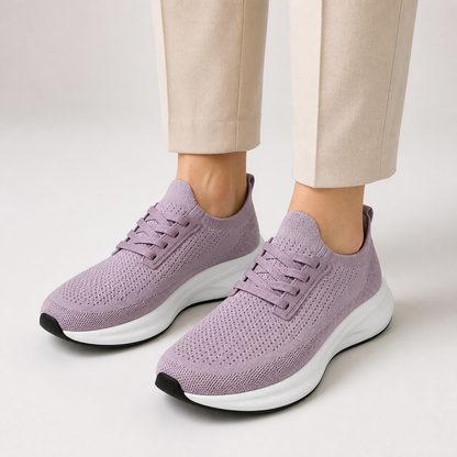 Dusty mauve wide toe trainers worn with cream tailored trousers