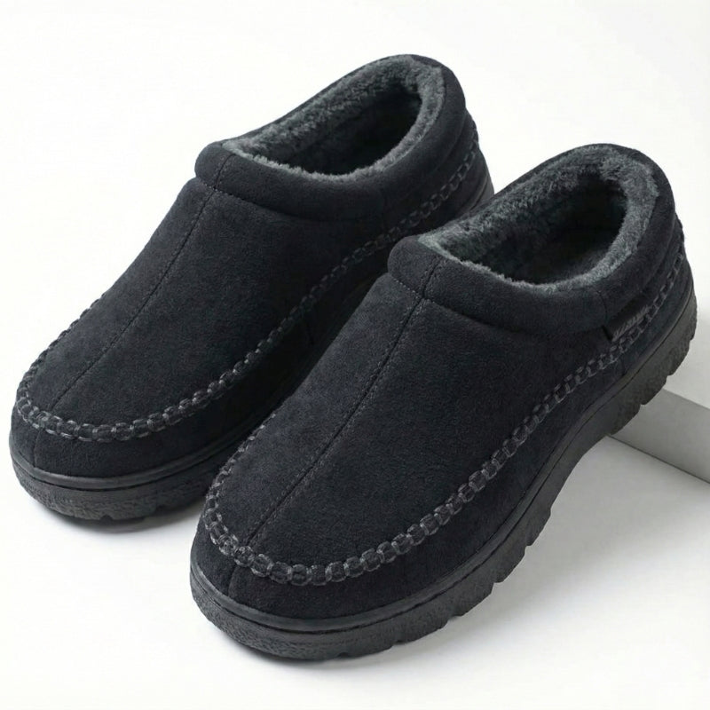 Black moccasin slippers showing the fleece-lined opening