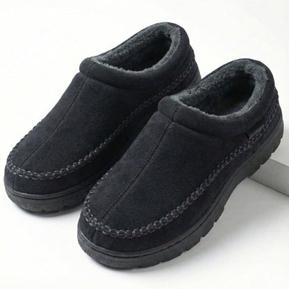 Black moccasin slippers showing the fleece-lined opening