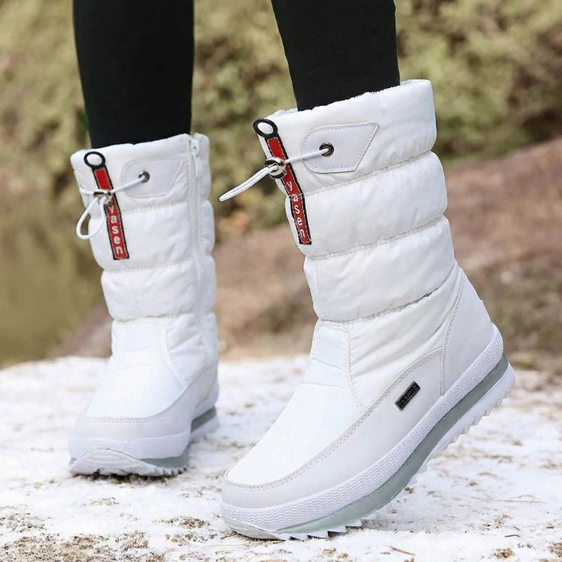 Auldweave women's waterproof mid-calf snow boots – white pair worn from the front in snow