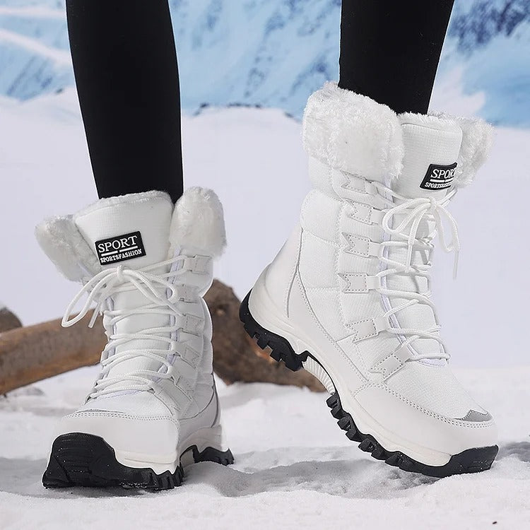 White lace-up winter boots with white fleece cuffs worn in snow