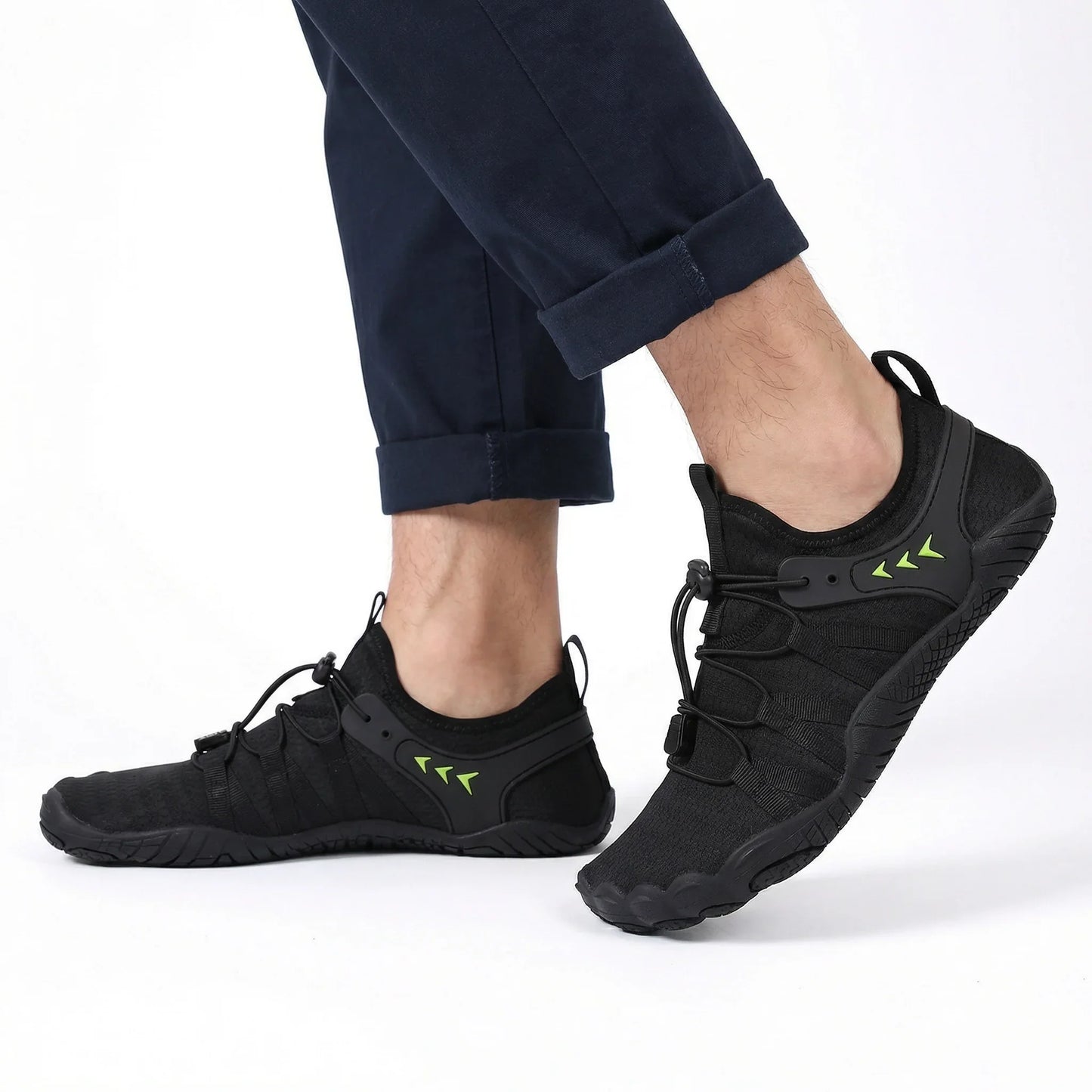Jet black walking shoes worn with dark trousers, side view