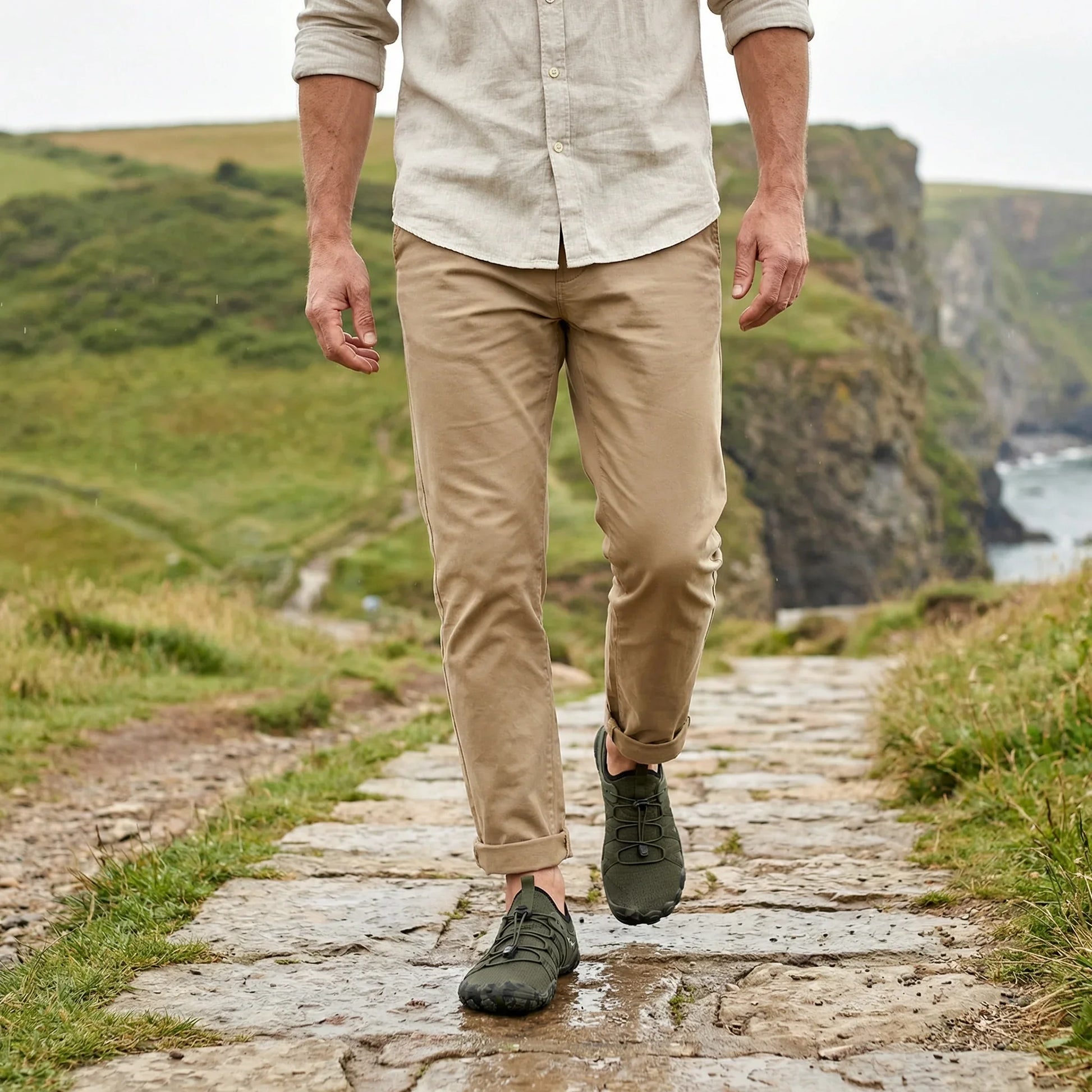 Forest green walking shoes worn on a coastal trail, front view