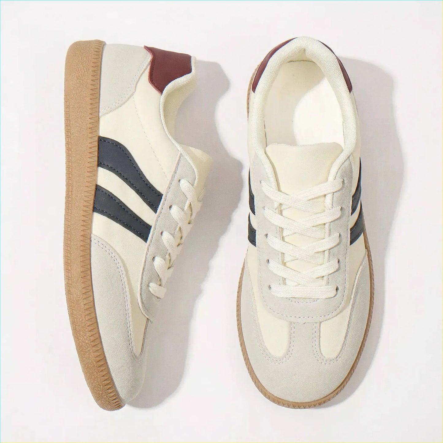 Cream and navy retro trainers for women, angled studio pair