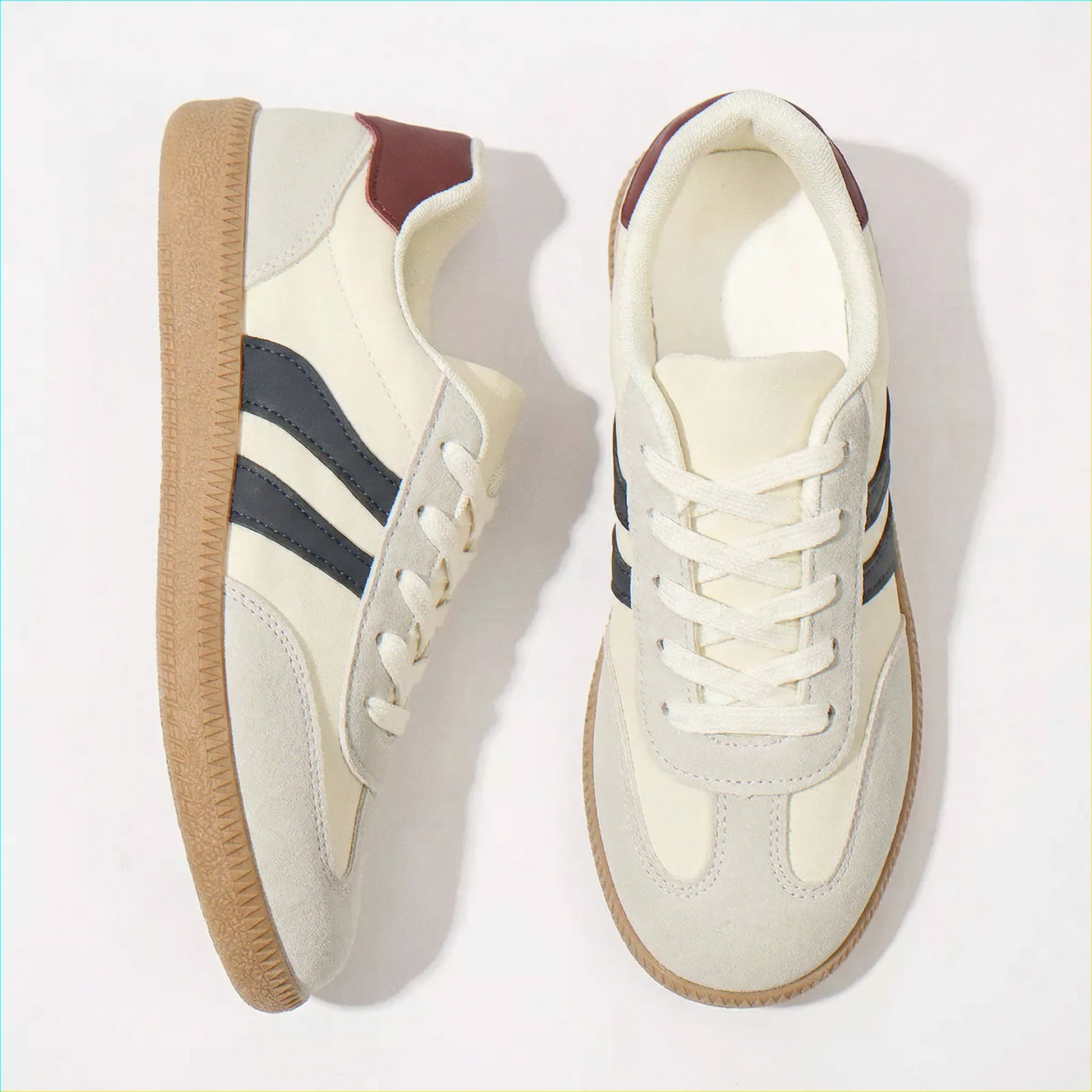 Cream and navy retro trainers for women, angled studio pair