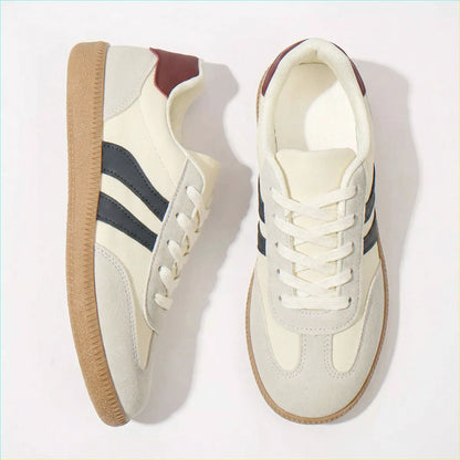 Cream and navy retro trainers for women, angled studio pair