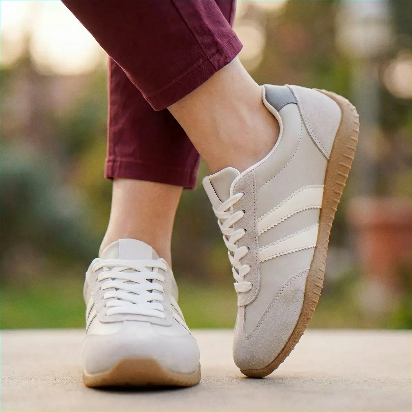 Cream and navy trainers for women, close on-foot park view