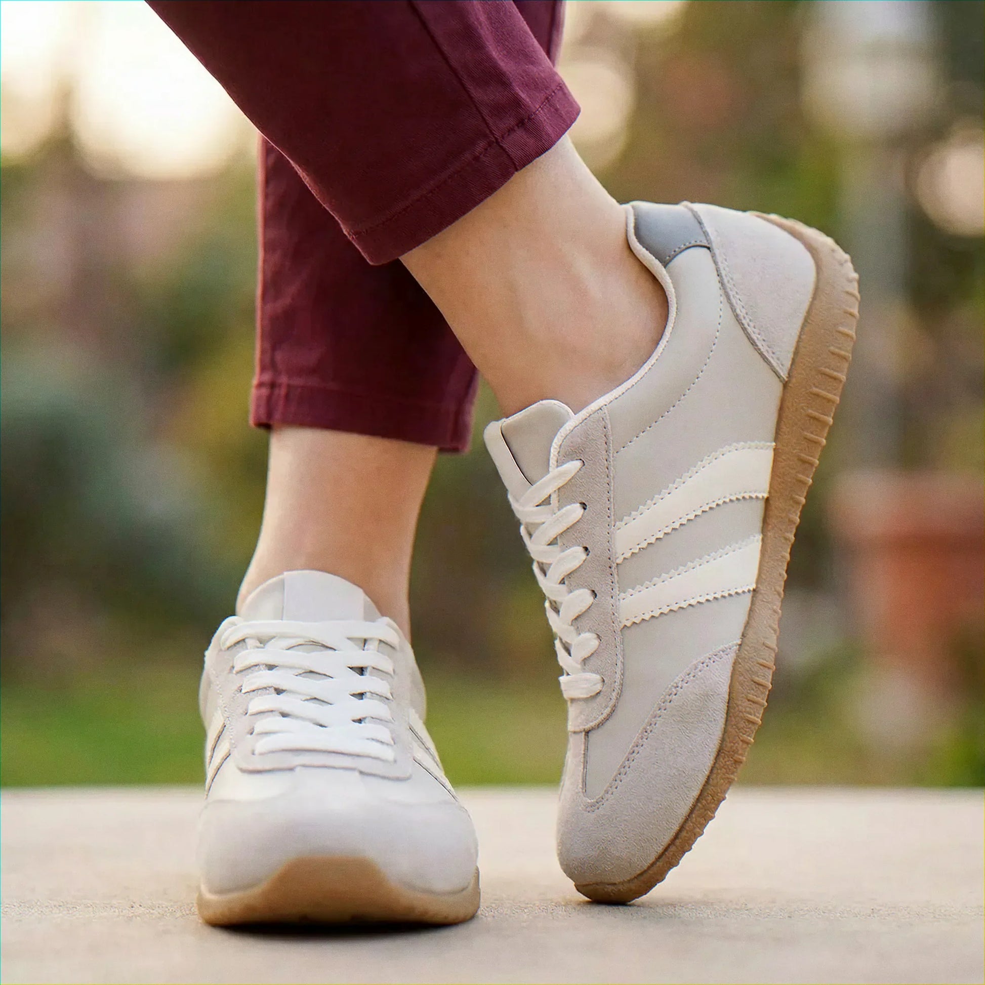 Cream and navy trainers for women, close on-foot park view