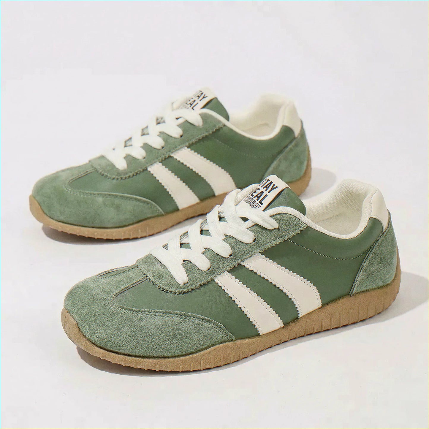 Olive green wide fit trainers, side and angled studio views