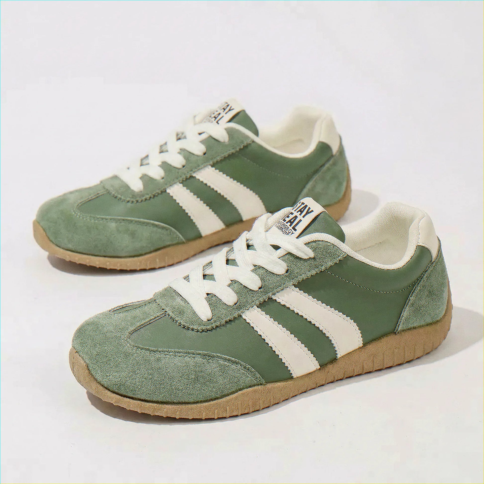 Olive green wide fit trainers, side and angled studio views