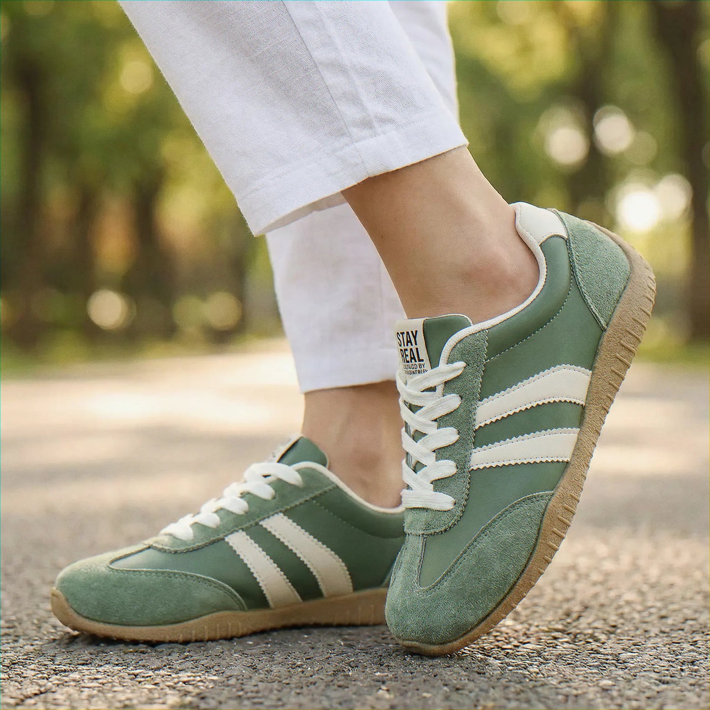 Olive green walking trainers, side on-foot path view