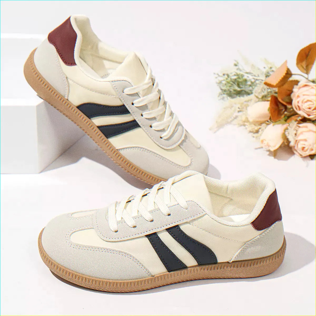 Cream and navy retro trainers for women, styled studio pair