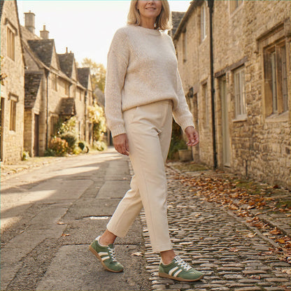 Woman wearing olive green trainers on a village street
