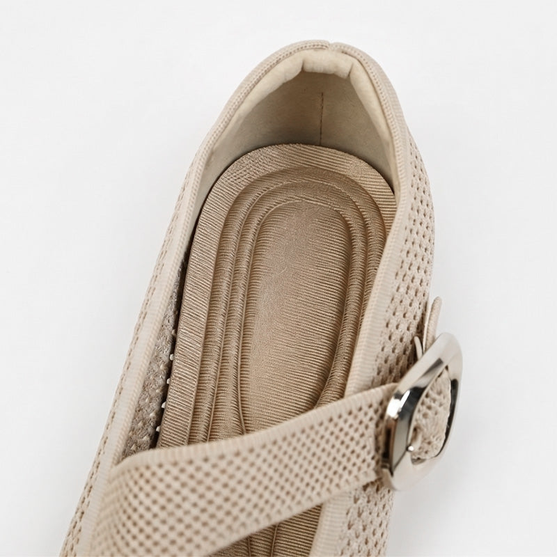 Close-up of beige Mary Jane flat with cushioned footbed and adjustable buckle strap