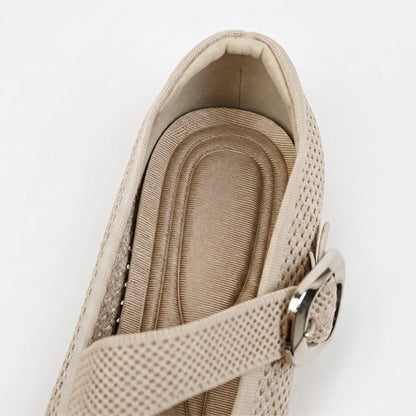 Close-up of beige Mary Jane flat with cushioned footbed and adjustable buckle strap