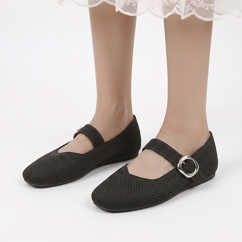Black Mary Jane flats with buckle straps worn from the front