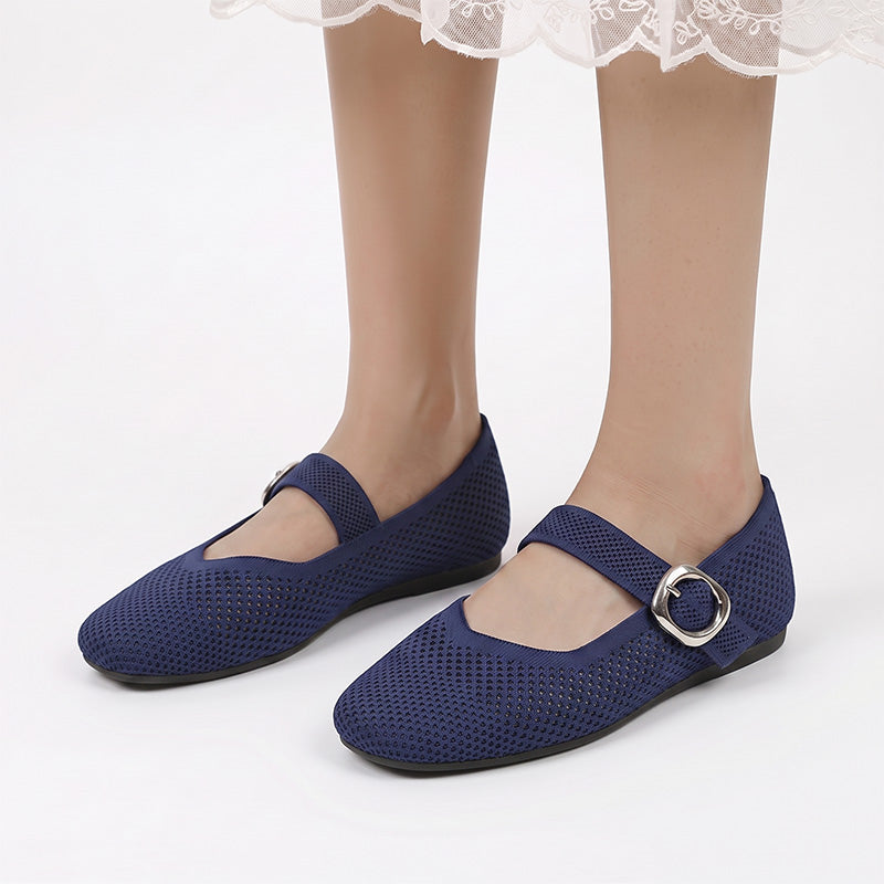 Navy Mary Jane flats with buckle straps worn from the front