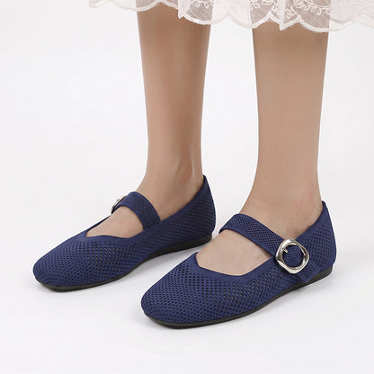 Navy Mary Jane flats with buckle straps worn from the front
