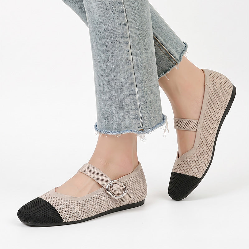 Beige and black Mary Jane flat shoes with buckle straps worn with jeans