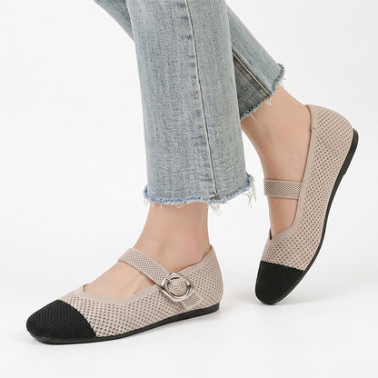 Beige and black Mary Jane flat shoes with buckle straps worn with jeans