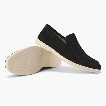 Black men's loafers shown from the side with outsole view