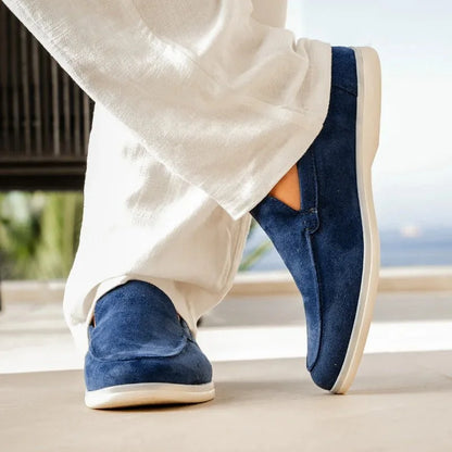 Marine blue men's slip on loafers worn with white trousers