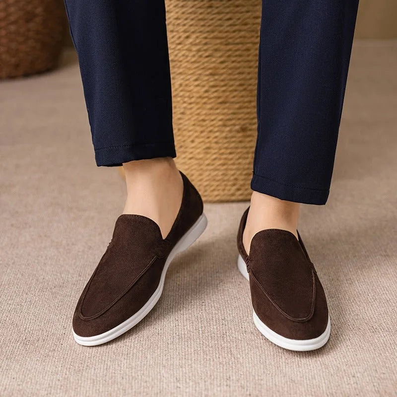 Chocolate brown men's slip on loafers worn with dark trousers