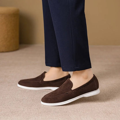 Chocolate brown men's loafers worn indoors, side view