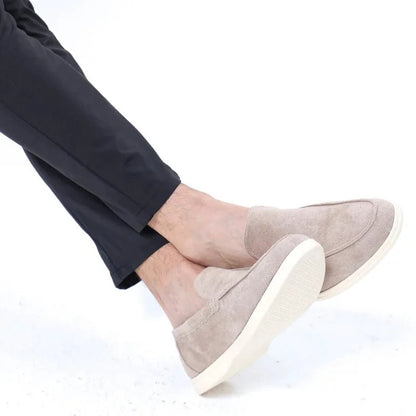 Light grey men's slip on loafers worn indoors, side view