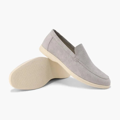 Light grey men's loafers shown from the side with outsole view