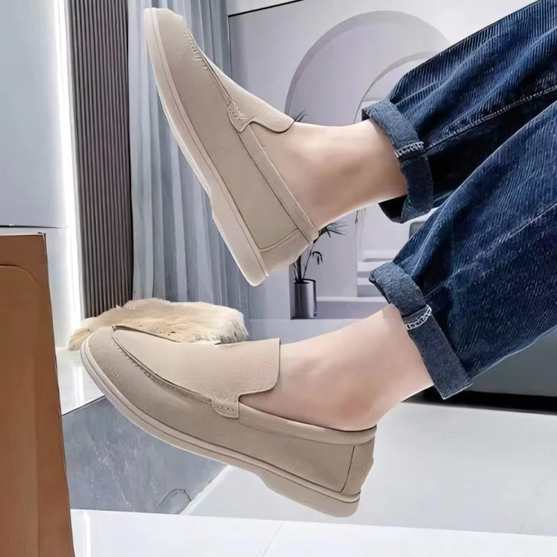 Light brown men's loafers worn while seated, close side view