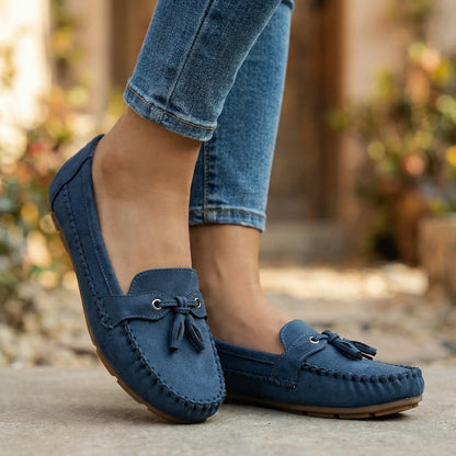Navy slip on loafers for women, worn outdoors with jeans
