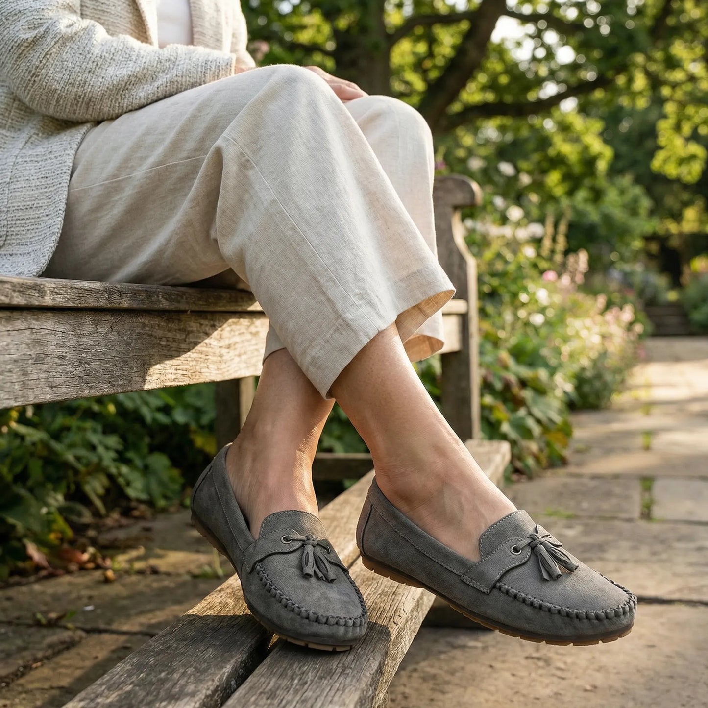 Grey slip on loafers for women, seated garden lifestyle view