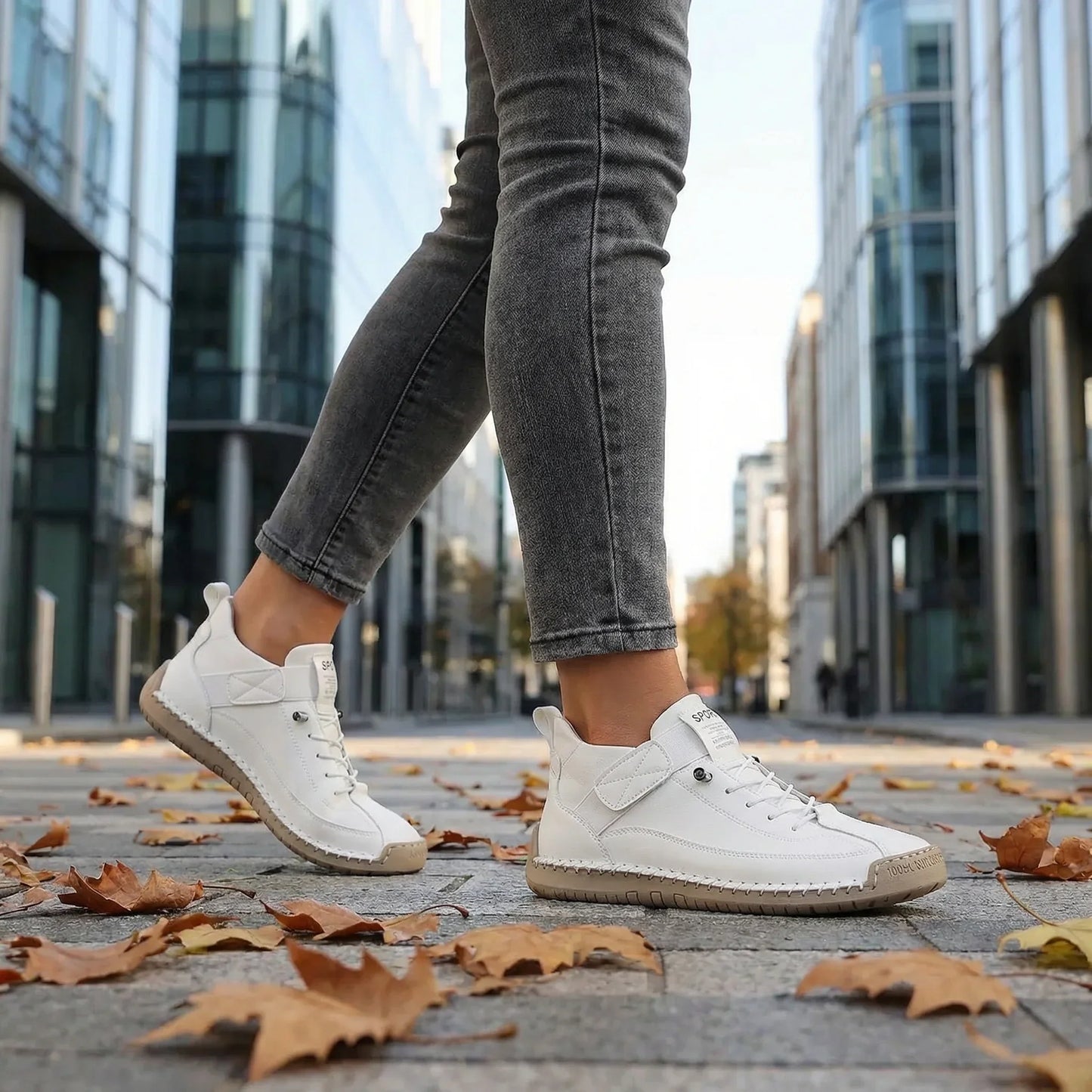 Woman wearing classic white wide fit walking trainers outdoors