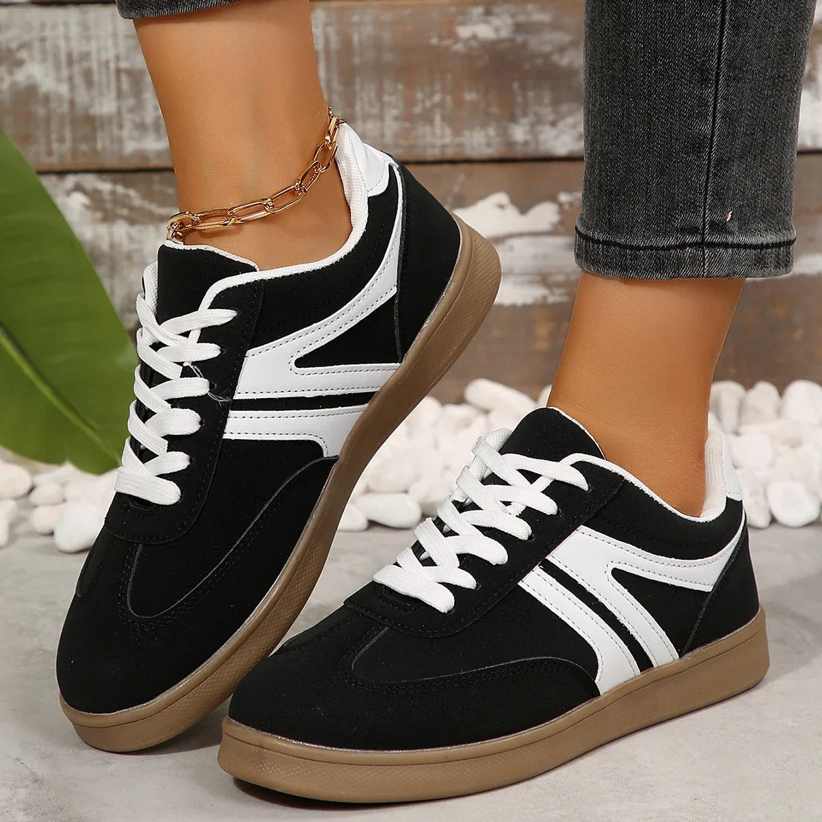 Black wide fit trainers for women, side on foot view
