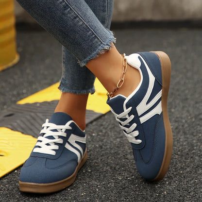 Navy walking trainers for women, angled on foot view
