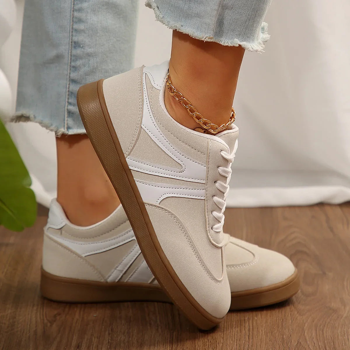 White retro trainers for women, side on foot view