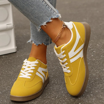 Yellow retro trainers for women, top down on foot street view