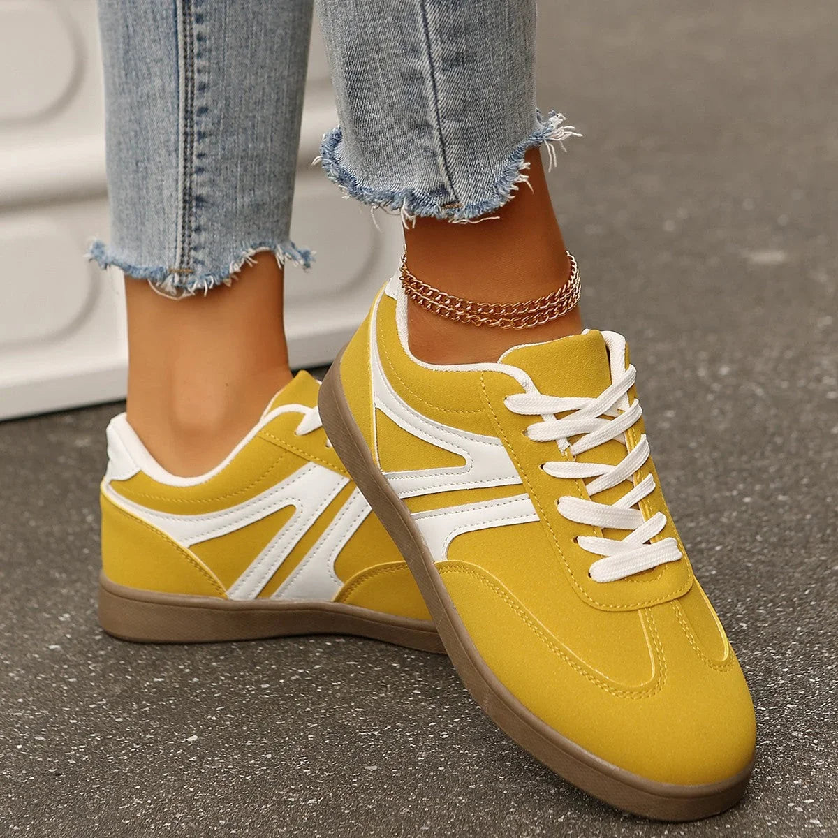 Yellow wide fit trainers for women, angled on foot view