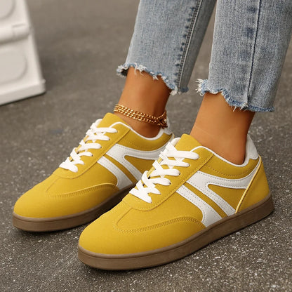 Yellow walking trainers for women, close on foot street view