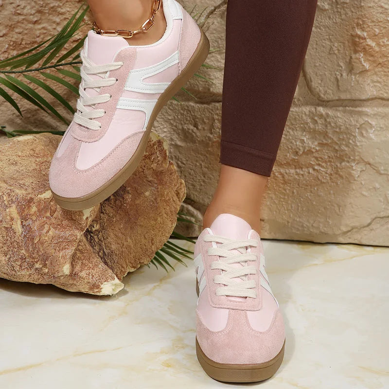 Pink walking trainers for women, front on foot studio view