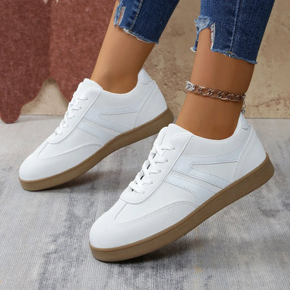 White retro trainers for women, angled on foot view