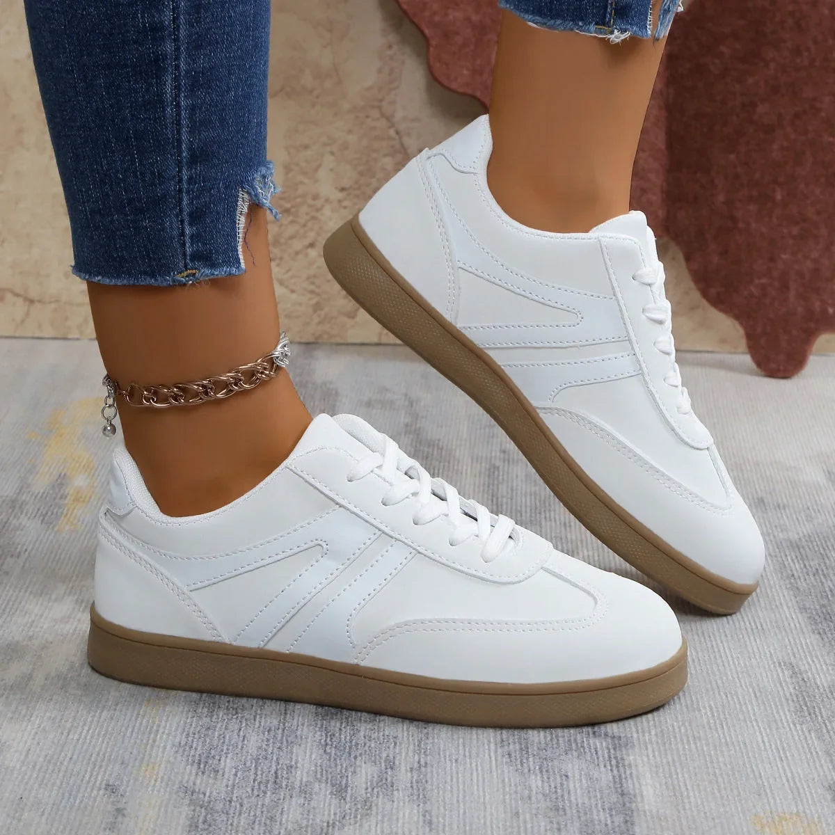 White walking trainers for women, front on foot studio view