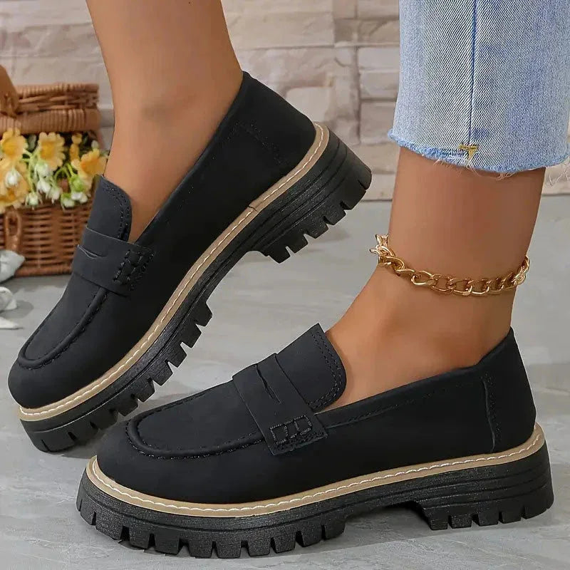 Black chunky loafers for women, on foot side view