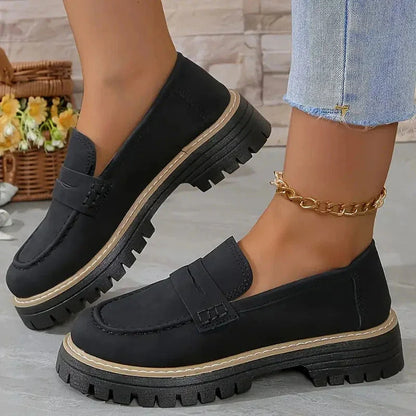 Black chunky loafers for women, on foot side view