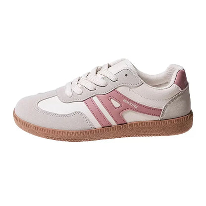Women's pink and white wide fit trainers, side profile on a white background
