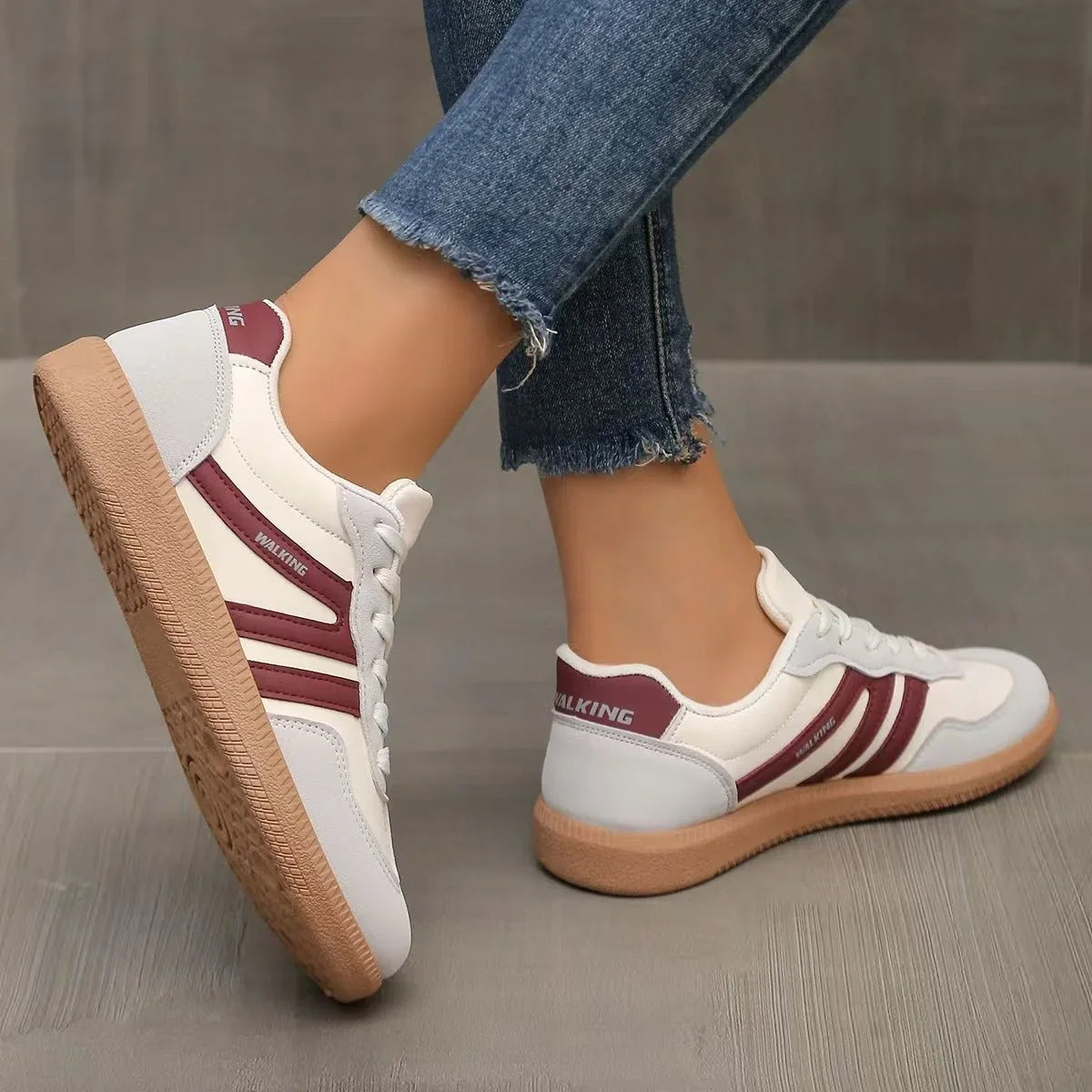 Women's white and burgundy retro trainers shown from the rear and side