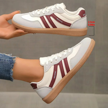 Women's white and burgundy retro trainers shown in side profile