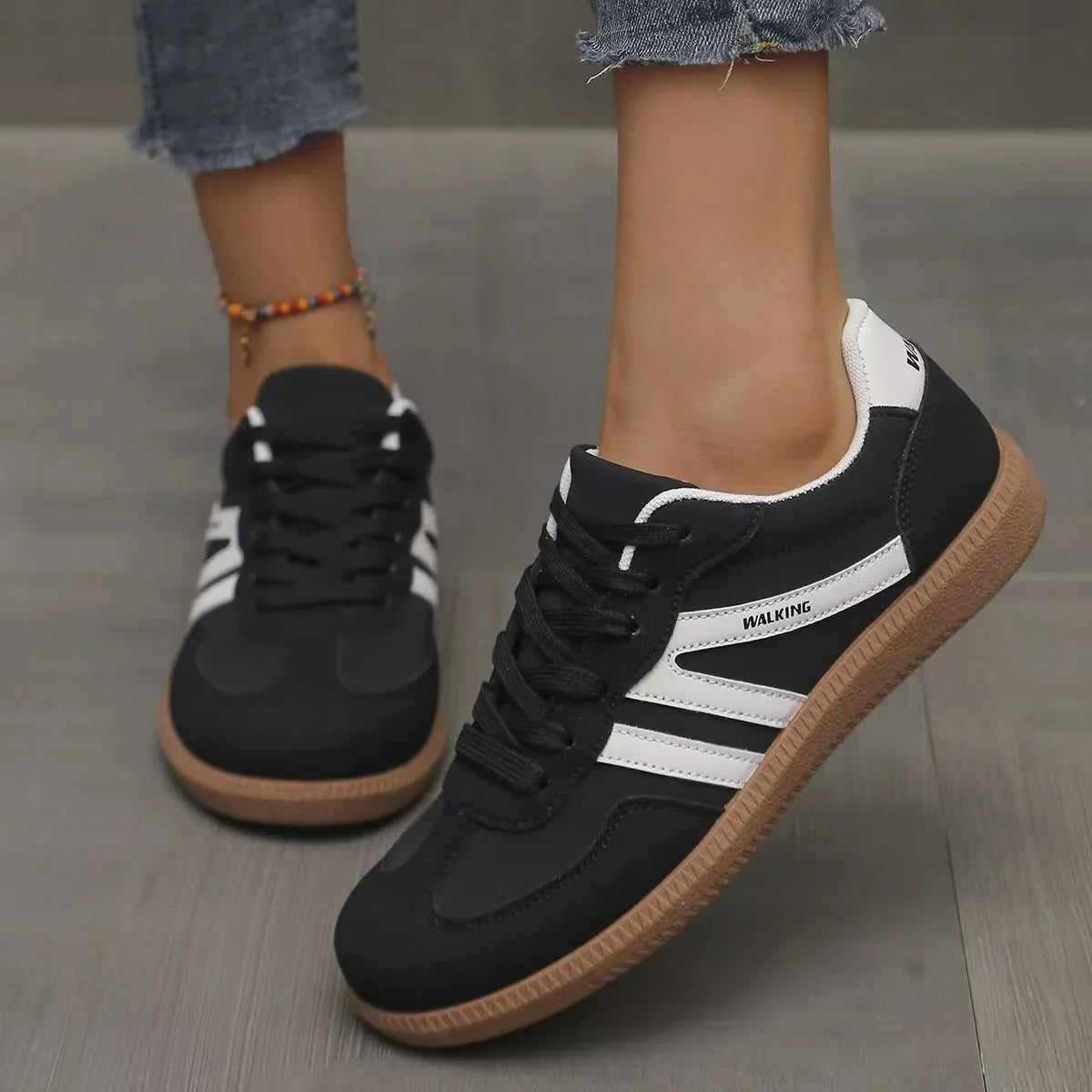 Women's black and white retro trainers worn from the front